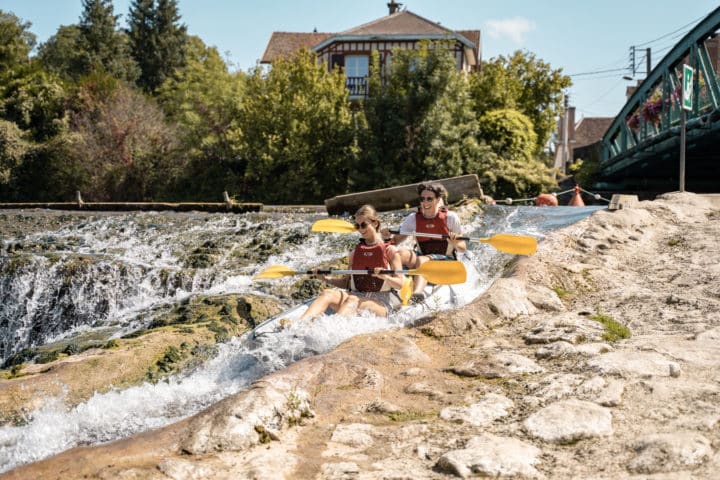 personnes en canoës descendant un cours d'eau